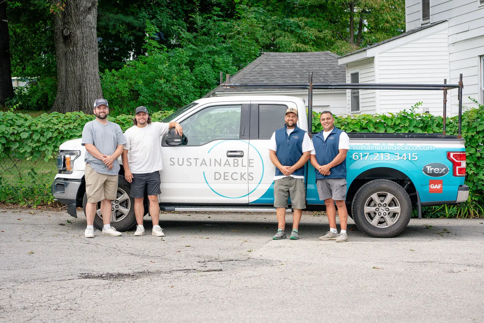 The Sustainable Decks crew beside a company truck